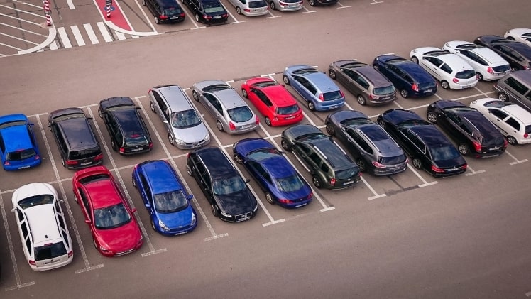 A picture of new cars protected by the Red Shield Administration parked in a car lot.